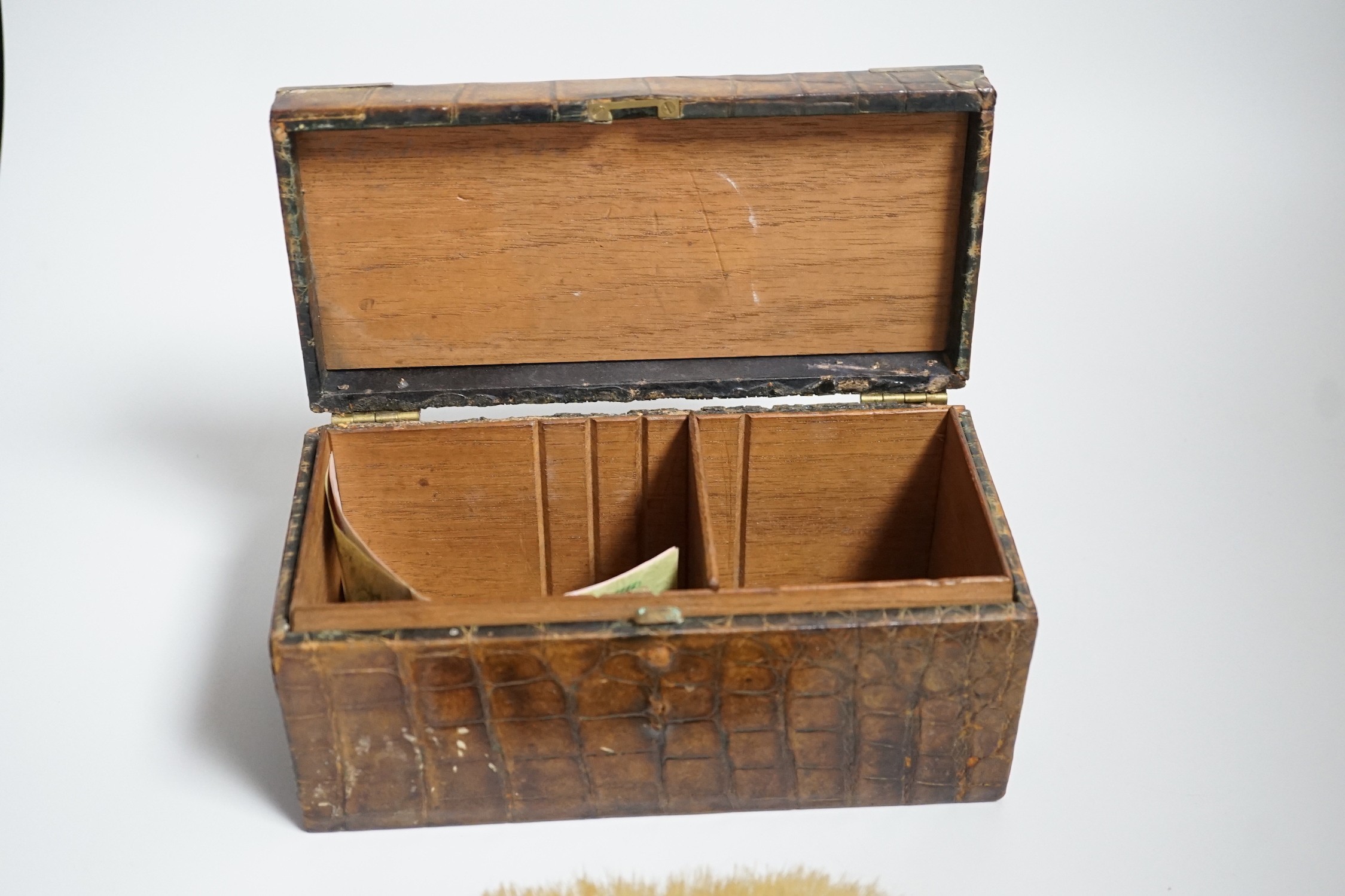 A late Victorian silver mounted crocodile skin jewellery box, 19cm and two silver and enamel mounted brushes.